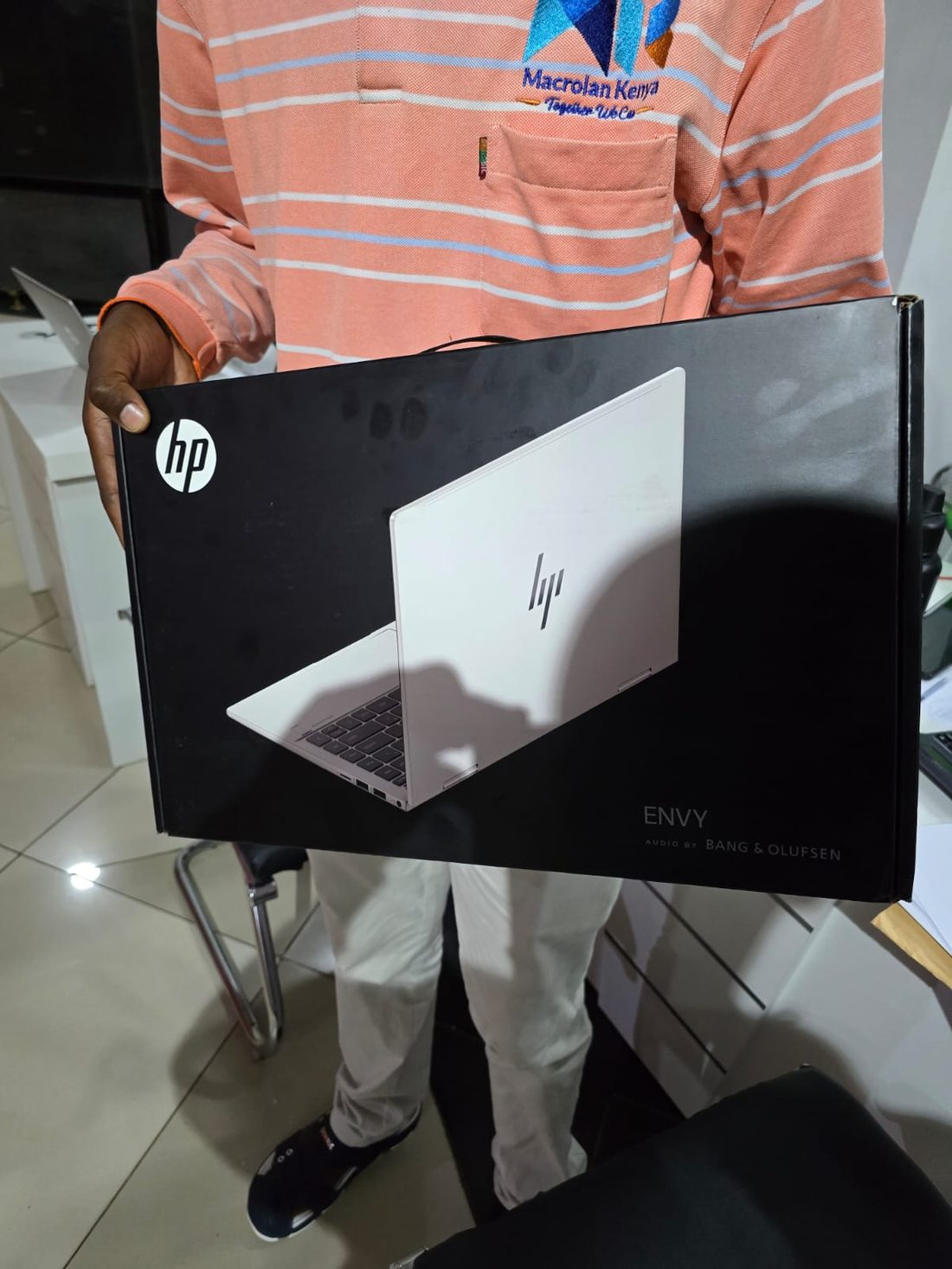 Macrolan staff supplying a new HP laptop to a client